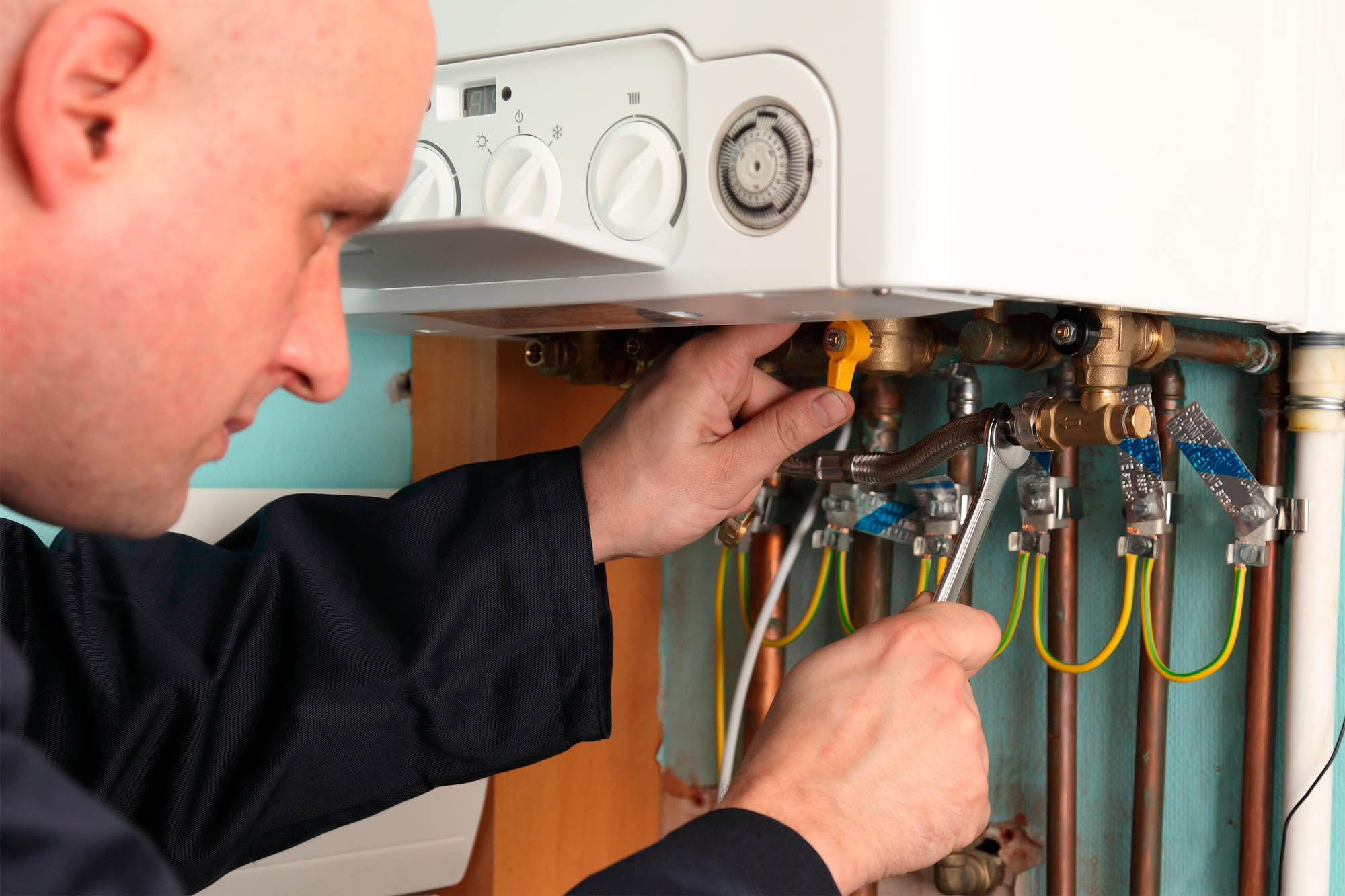 UK gas engineer fitting a boiler